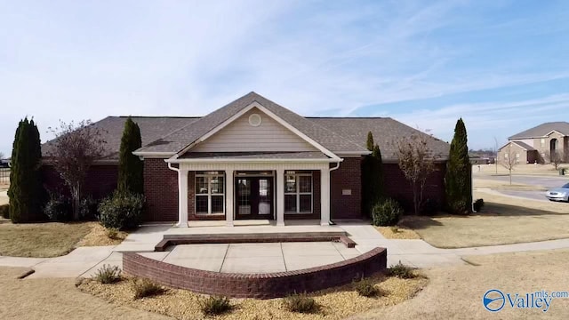 rear view of property featuring french doors