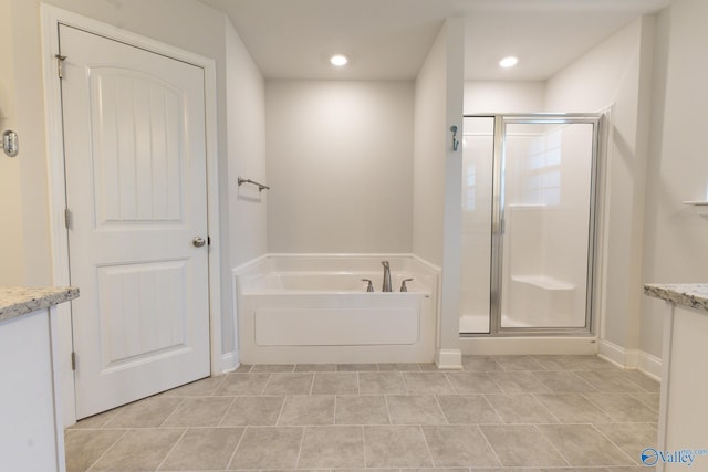 bathroom featuring tile patterned flooring, vanity, and shower with separate bathtub