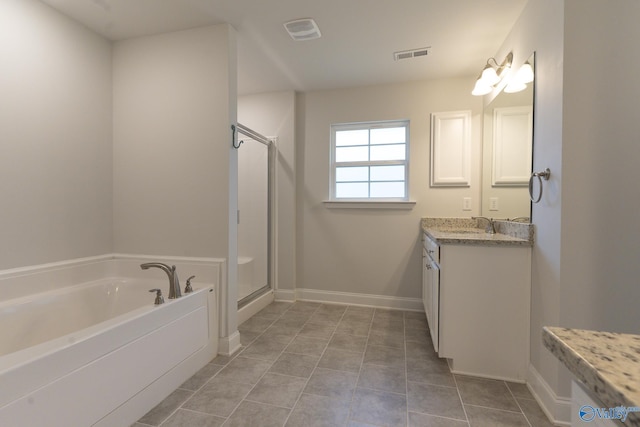 bathroom with tile patterned flooring, vanity, and shower with separate bathtub