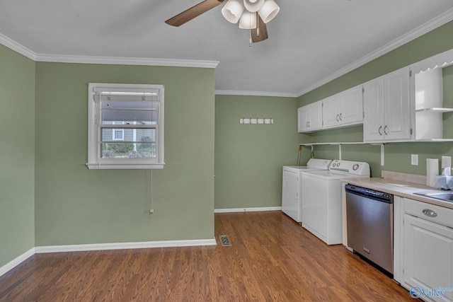 laundry room featuring dark wood-style floors, baseboards, ornamental molding, and separate washer and dryer