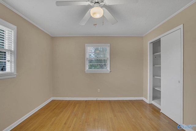 unfurnished room with baseboards, crown molding, and light wood finished floors