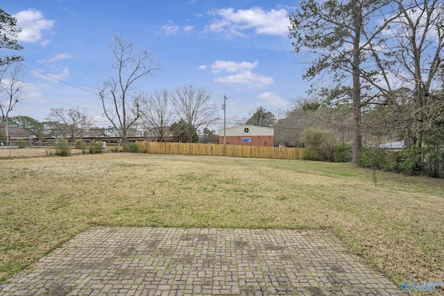 view of yard featuring a patio and fence