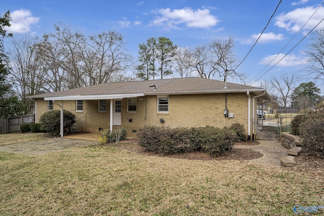 back of house featuring a lawn, crawl space, a gate, fence, and brick siding