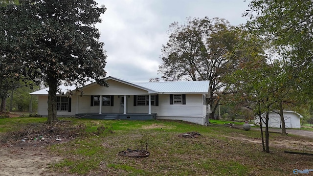 view of front of house featuring a garage, an outdoor structure, and a porch