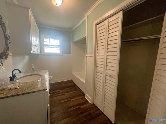 bathroom with ornamental molding, hardwood / wood-style floors, vanity, and toilet