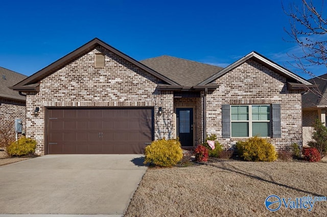 view of front of house with concrete driveway, brick siding, roof with shingles, and an attached garage