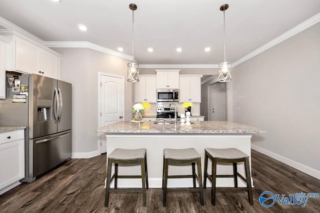 kitchen featuring stainless steel appliances, white cabinets, a kitchen island with sink, and decorative light fixtures