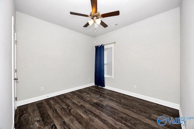 empty room with baseboards, visible vents, ceiling fan, and wood finished floors