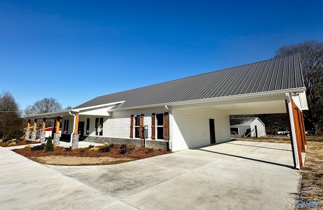 view of front of house featuring a shed, a carport, and covered porch