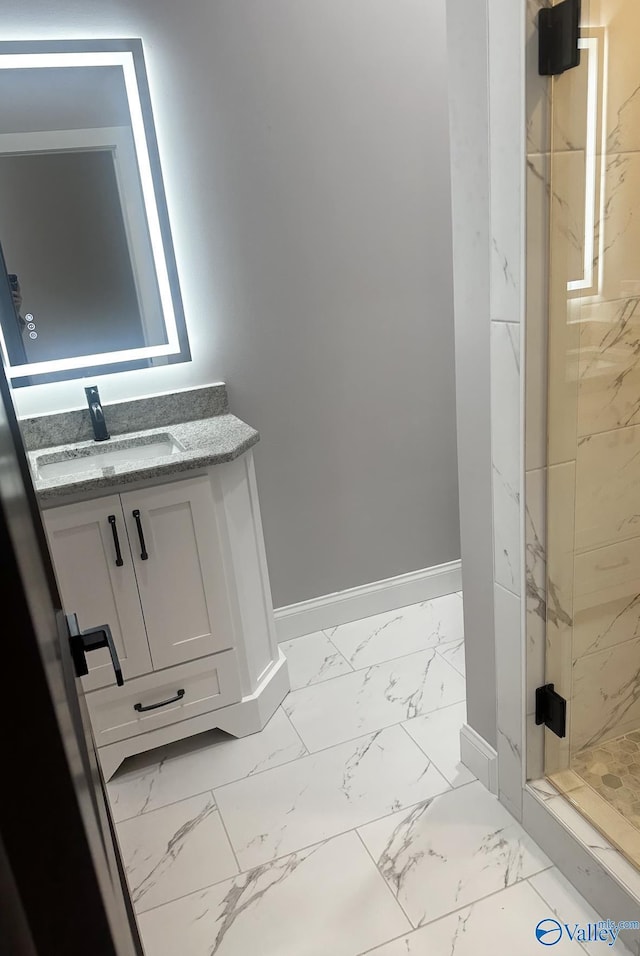 bathroom with vanity and tiled shower