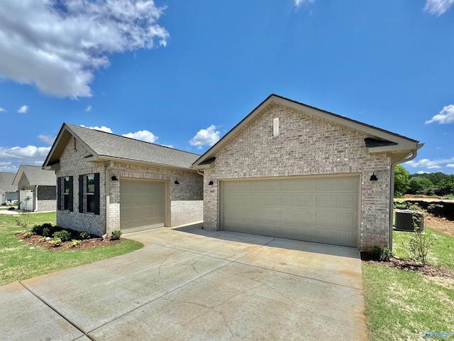 211 Shangrila Way, Meridianville, AL 35759 - ranch-style home featuring brick siding, concrete driveway, a garage, and cooling unit