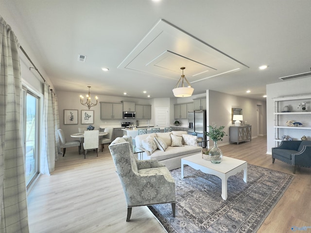 211 Shangrila Way, Meridianville, AL 35759 - living area with light wood-type flooring, attic access, baseboards, a chandelier, and recessed lighting