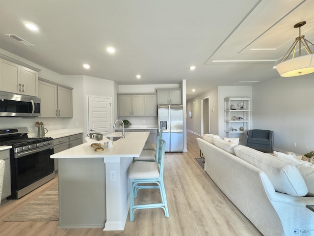 211 Shangrila Way, Meridianville, AL 35759 - kitchen with appliances with stainless steel finishes, gray cabinets, open floor plan, light wood-type flooring, and light countertops