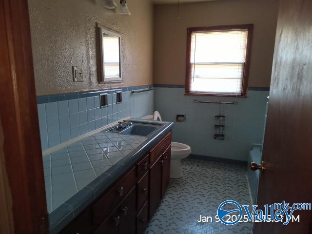 bathroom with tile patterned floors, vanity, and toilet