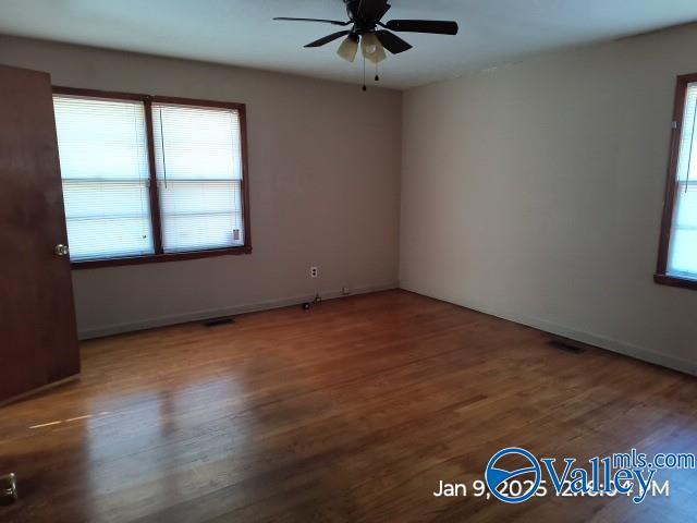 spare room featuring hardwood / wood-style floors and ceiling fan