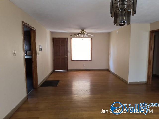 empty room with ceiling fan and wood-type flooring