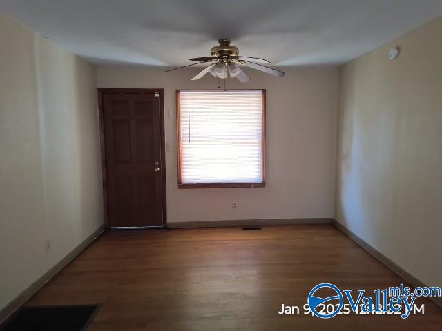 empty room featuring wood-type flooring and ceiling fan