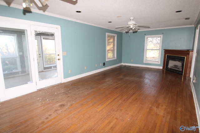 unfurnished living room with hardwood / wood-style flooring, ceiling fan, crown molding, and a textured ceiling