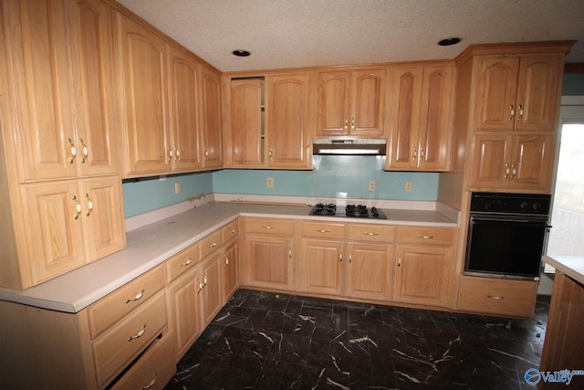 kitchen featuring black appliances and a textured ceiling