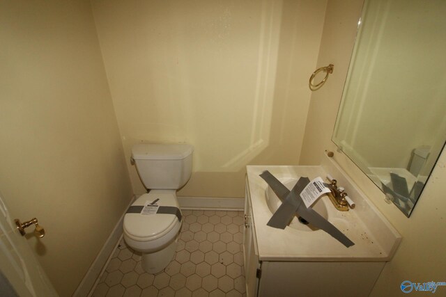 bathroom featuring tile patterned flooring, vanity, and toilet