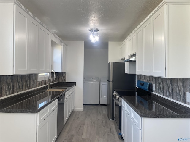 kitchen featuring a sink, stainless steel range with electric cooktop, dishwasher, tasteful backsplash, and washer and clothes dryer