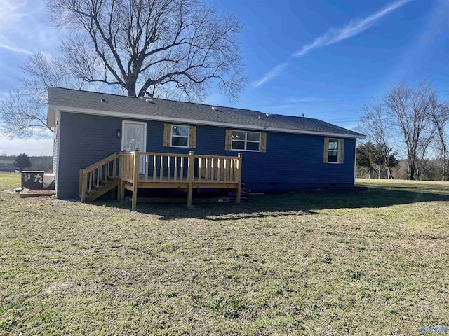 back of property featuring a lawn and a wooden deck