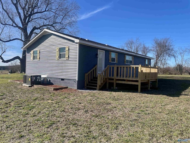 rear view of house with cooling unit, crawl space, a yard, and a deck