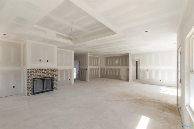 unfurnished living room featuring a brick fireplace