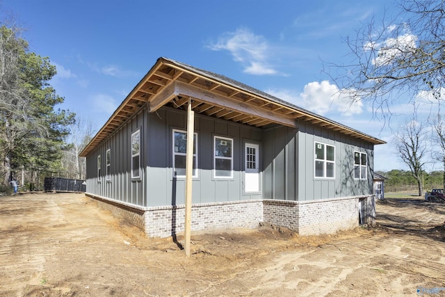 view of home's exterior featuring brick siding and board and batten siding