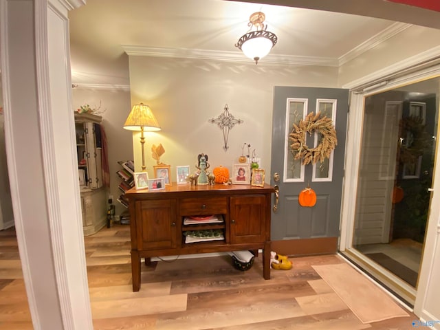 interior space with light hardwood / wood-style flooring and ornamental molding