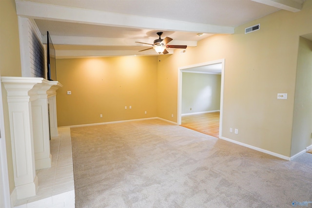 unfurnished living room with beamed ceiling, ceiling fan, light carpet, and baseboards