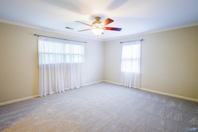 unfurnished room featuring ornamental molding, a ceiling fan, carpet, and baseboards