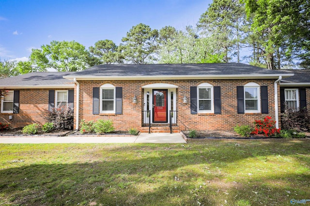 ranch-style house with brick siding and a front lawn
