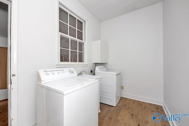 2512 Vista Dr SE, Huntsville, AL 35803 - laundry room featuring washing machine and dryer, light wood finished floors, and baseboards