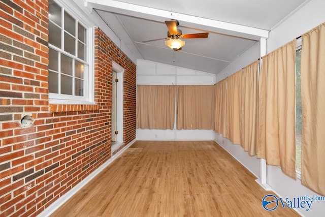 interior space featuring ceiling fan and vaulted ceiling with beams