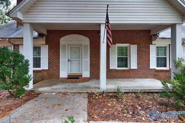 view of exterior entry featuring a porch