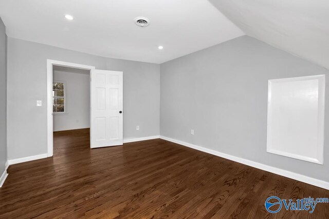 2512 Vista Dr SE, Huntsville, AL 35803 - spare room featuring dark wood-style flooring, lofted ceiling, baseboards, and recessed lighting