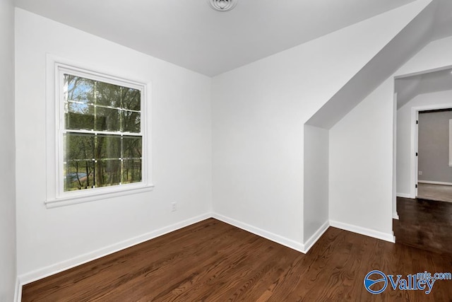 additional living space with dark hardwood / wood-style floors