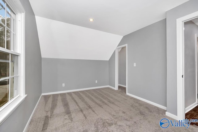 bonus room featuring lofted ceiling and carpet floors