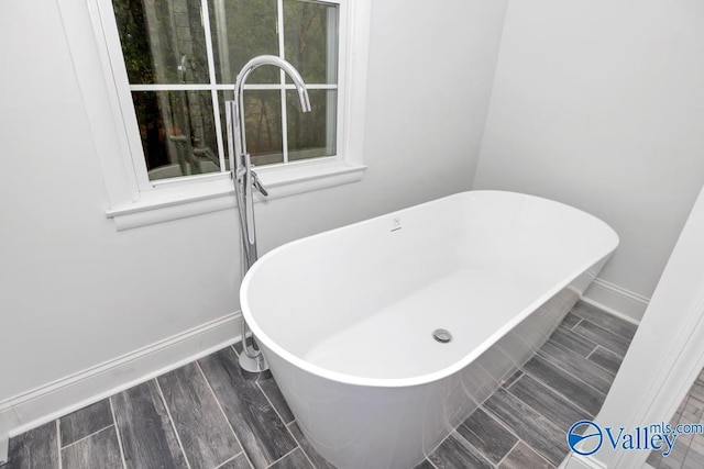 2512 Vista Dr SE, Huntsville, AL 35803 - full bathroom with a freestanding tub, baseboards, and wood finished floors