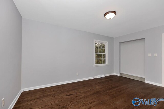 spare room featuring dark hardwood / wood-style floors