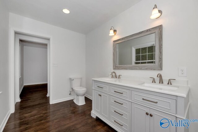 2512 Vista Dr SE, Huntsville, AL 35803 - bathroom with toilet, wood finished floors, double vanity, and baseboards