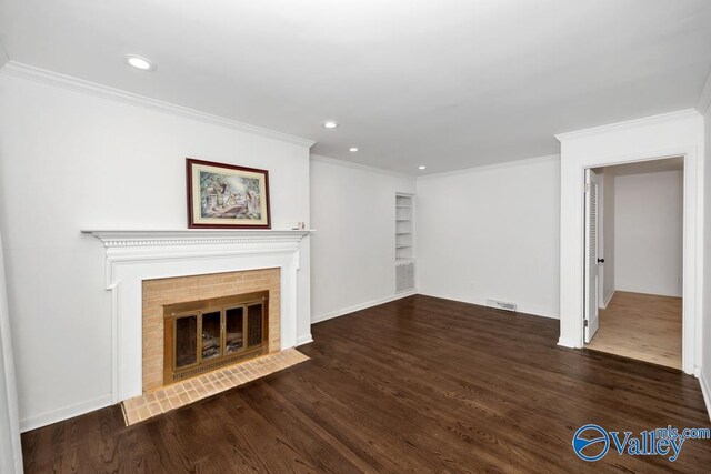 2512 Vista Dr SE, Huntsville, AL 35803 - unfurnished living room with ornamental molding, wood finished floors, recessed lighting, a brick fireplace, and baseboards