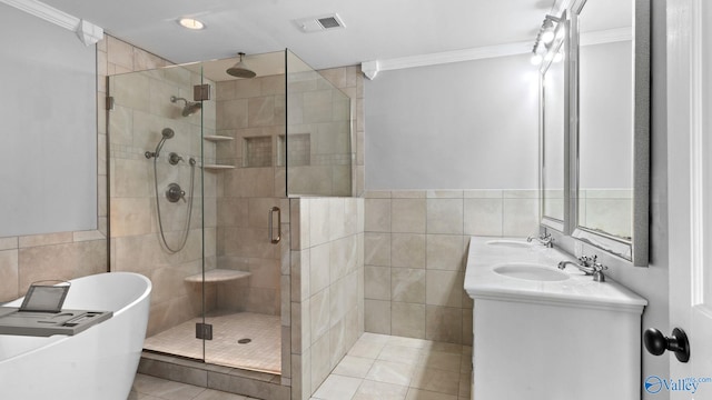 919 Colquitt Rd, Gadsden, AL 35903 - full bath featuring tile walls, a stall shower, a freestanding tub, crown molding, and double vanity