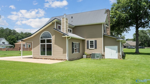919 Colquitt Rd, Gadsden, AL 35903 - back of house featuring a chimney, a lawn, a patio, and a metal roof
