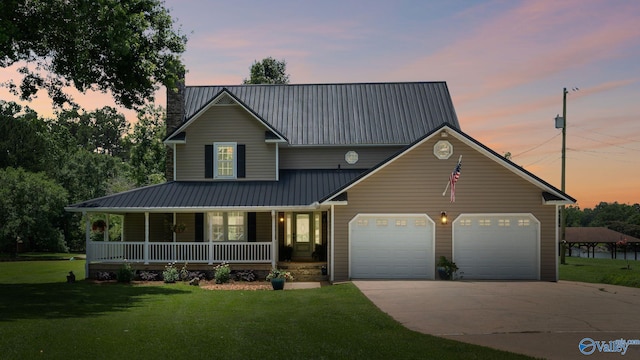 919 Colquitt Rd, Gadsden, AL 35903 - view of front of property featuring covered porch, driveway, a lawn, a garage, and a metal roof