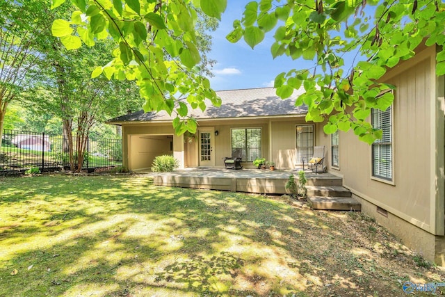 back of house featuring a yard and a deck