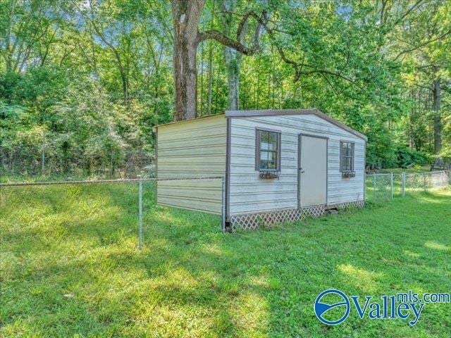 view of shed with a wooded view