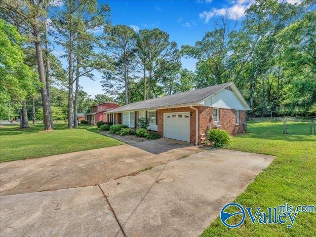 view of front of property with a garage, a front yard, brick siding, and concrete driveway