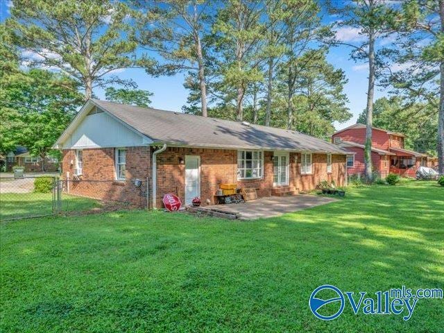 rear view of house with a patio and brick siding